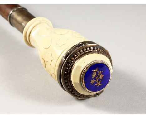 A SUPERB 19TH CENTURY RUSSIAN CARVED IVORY AND SILVER WALKING STICK, the handle as a snuff box with blue enamel plaque. 38ins