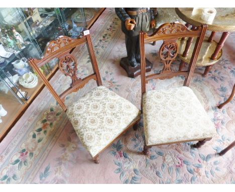 EDWARDIAN CHAIRS. Pair of Edwardian low upholstered chairs with ceramic castors 