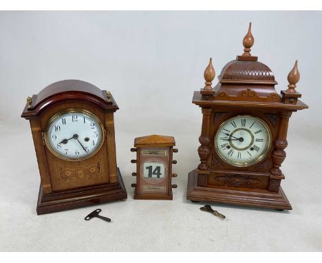 Two mantel clocks, an inlaid mahogany example with key and a walnut finialled example manufactured by Sukosha Tokyo Japan, la