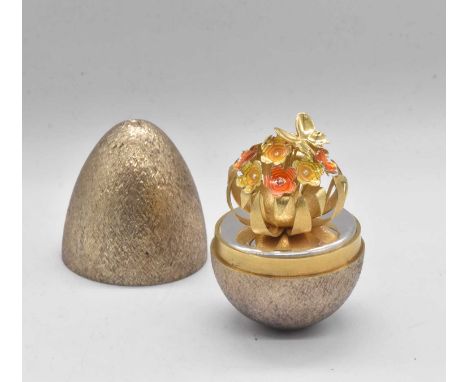 STUART DEVLIN; an Elizabeth II hallmarked silver Easter egg, with floral sprays and butterfly, no. 97, hallmarked London 1981