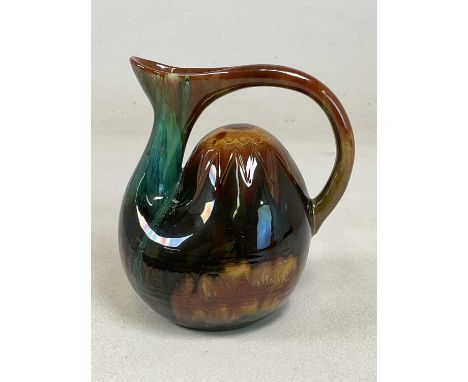 DR. CHRISTOPHER DRESSER FOR LINTHORPE POTTERY; a humpbacked jug with extended handle, incised motifs and streaked glaze, impr