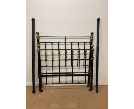 A 19th century cast iron and brass bedstead on castors, height 151cm width 122cm, length 180cm.