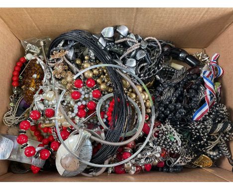 A large collection of costume jewellery including simulated beads, 19th century buckle, various cuff bangles, choker, etc.