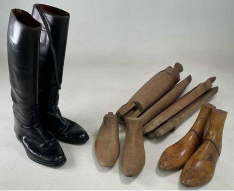 A pair of black hunting boots, size 7, with boot stretchers and shoe trees.