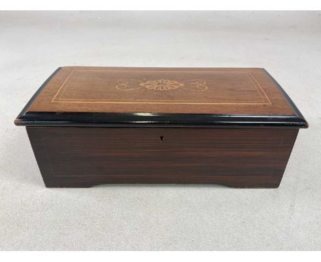 A late 19th century six air music box , simulated rosewood, with 6" barrel, width 36 cm, all teeth in good condition.Conditio