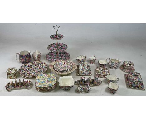 A quantity of chintz pattern ceramics comprising a three tier stand, a toast rack, a butter dish, tea pots, etc.