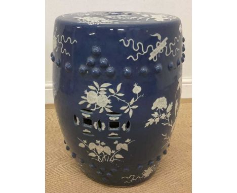 A Chinese blue and white garden seat of barrel form, with raised stud detail and well decorated with auspicious symbols and f