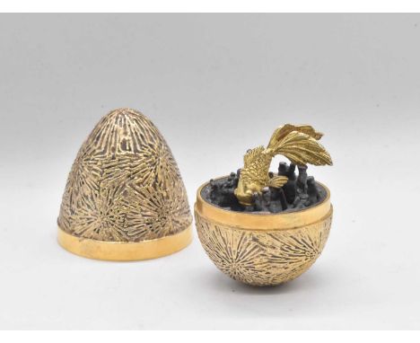 STUART DEVLIN; an Elizabeth II hallmarked silver gilt Easter egg, enclosing a fish swimming amongst coral, no. 271, hallmarke