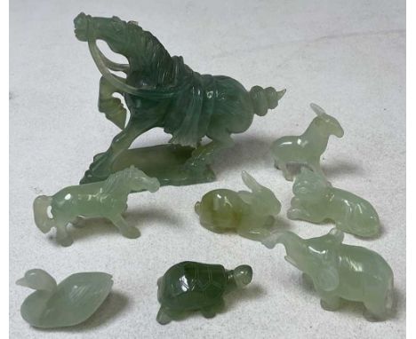 A group of Chinese jade and similar carvings including elephant, horse, swan, kitten, rabbit, etc, the largest length 14.5cm.