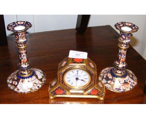 A pair of Royal Crown Derby candlesticks together with a Royal Crown Derby mantel clock