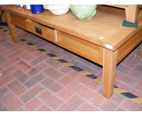 A contemporary light oak coffee table - width 140cm 