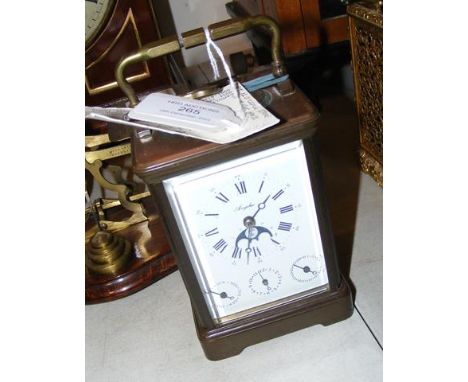 A brass cased repeater carriage clock with rolling moon phase and three subsidiary dials - 15cms high CONDITION REPORT Condit