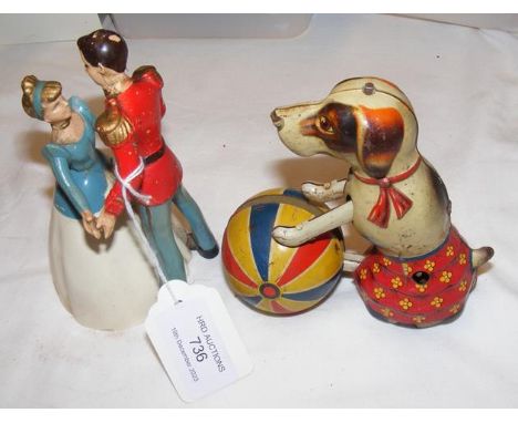 A clockwork Cinderella and Prince Charming novelty model, together with a tin plate clockwork dog toy
