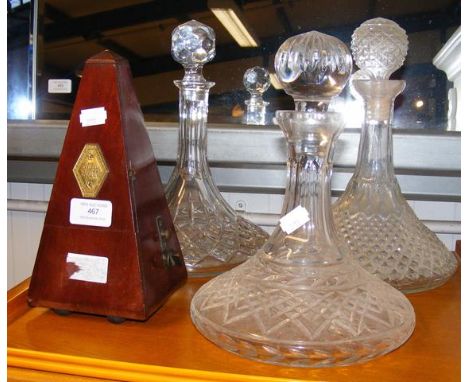 Three cut glass ship's decanters, together with a Maelzel Paquet metronome  CONDITION REPORT all bases approx. 18cms2 are 27c