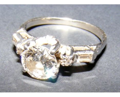 A ladies diamond solitaire ring (approx. 1.5 carat) in platinum setting with diamond baguette cut mounted shoulders