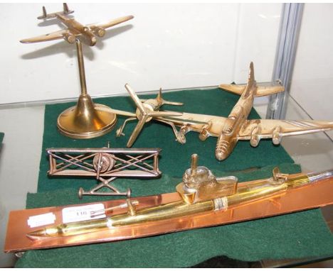 Four assorted Trench Art model aeroplanes, together with a ditto submarine 
