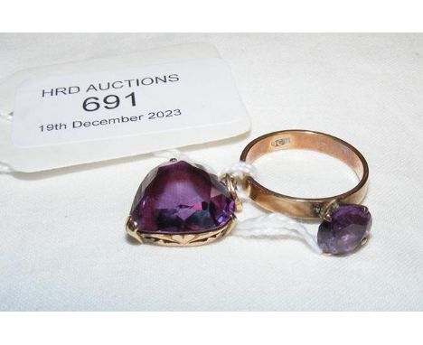 An amethyst ring in gold setting together with matching pendant