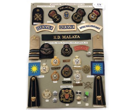 Royal Malaysian Army, Navy and Air Force 40 items of insignia.  Board with good display of metal and cloth badges including S