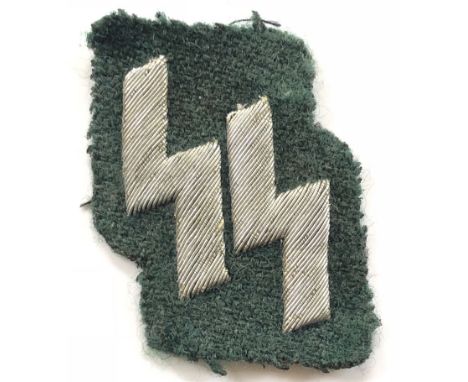 German Third Reich Waffen SS breast badge.  Fine rare silver aluminium wire embroidered SS Sigrunen on green cloth. Removed f