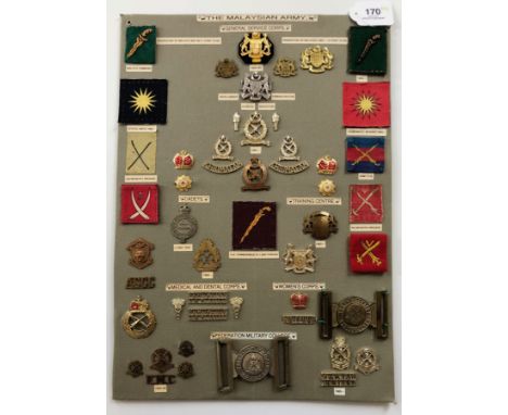 Malaysian Army 49 items of insignia.  Board with good display of metal and cloth badges including two waist belt clasps. Most