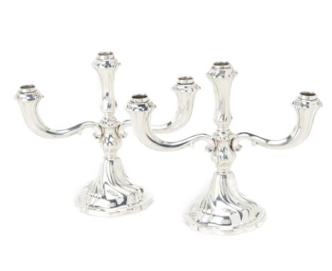 A PAIR OF GERMAN SILVER THREE LIGHT CANDELABRA
Late 19th/20th Century, 835 standard, 
With wrythen fluted decoration
26cm hig