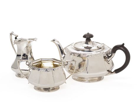 A SILVER THREE PIECE TEA SERVICE
Goldsmiths &amp; Silversmiths Co, London, 1913
Octagonal baluster form with a pierced scroll