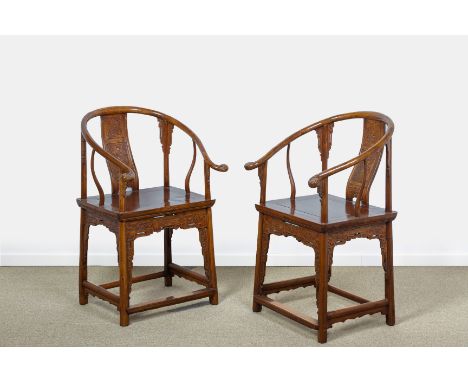 A PAIR OF CHINESE HORSESHOE-BACK ARMCHAIRS
The top rail with scroll carved terminals, the splat carved in shallow relief with