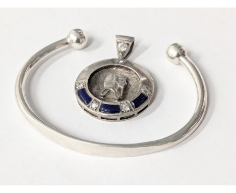 A silver bangle with silver pendant. 26g