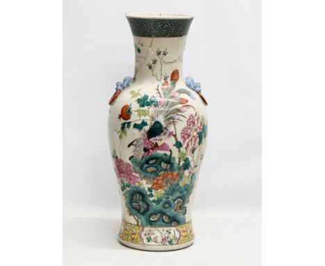A large Late Qing Dynasty Chinese Famille Rose pot. Decorated with hand painted peacocks, lotus leaves and 2 lion mask ring h