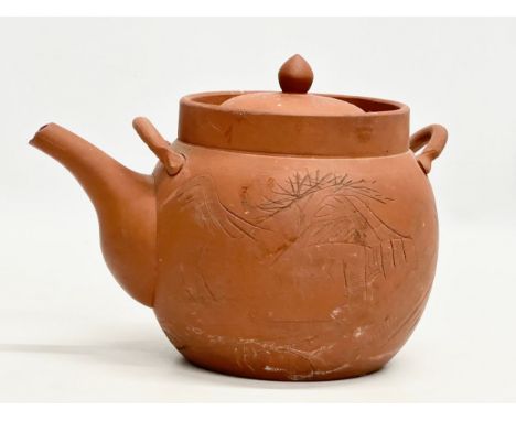A signed Early 20th Century Chinese Yixing teapot. Impressed mark. 22x14x16cm.