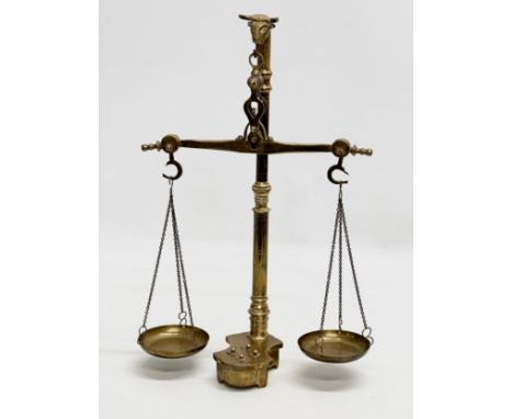 An Early 20th Century brass weight scales. 22x35cm.