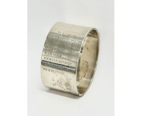 A Navy themed silver napkin ring. From a few shipmates, Xmas 1925. R.N. Staff College, H.M.S Ceres, H.M.S Marlborough, H.M.S 