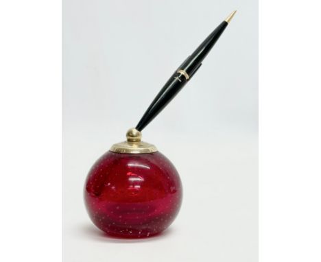 A Whitefriars ruby glass paperweight pen holder by Parker.