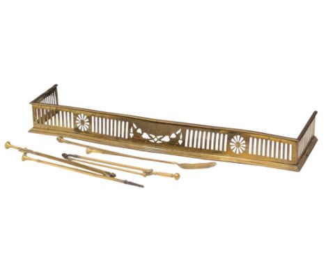 A Late 19th Century brass fire surround with brass fire tools. 140x31.5cm