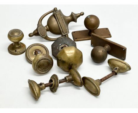 A collection of Victorian brass door handles and a later door knocker.