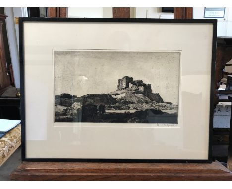 Leonard Squirrell, an etching of Bamburg Castle Northumberland. Signed lower right.  13½ by 8ins.  In an ebonised frame.  Est