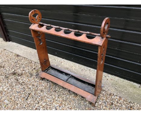 A late Victorian oak umbrella/stick stand with pierced end supports and drip tray to the lower section.  28¼ins wide (af).  E