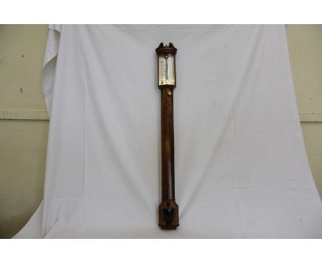 An 18th century style mahogany cased stick barometer, the scrolled pediment with central brass finial, silvered back plate to