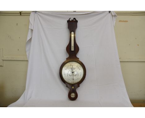 A 19th century mahogany banjo barometer/thermometer with broken arched pediment above a thermometer with silvered back plate,