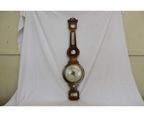 A 19th century mahogany cased banjo barometer/thermometer/hygrometer with brass finial, broken arch pediment above a silvered