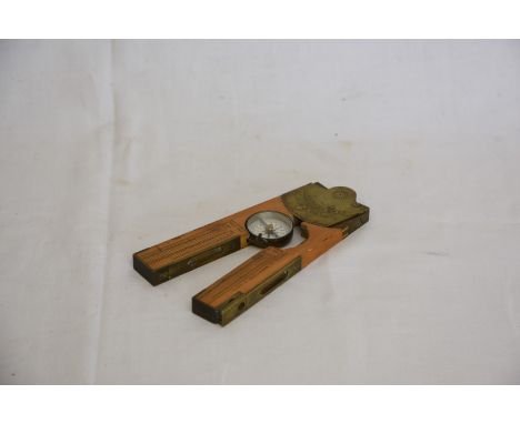 A 19th century boxwood and brass inclinometer by R Nicholl, 153 High Holborn, London. With central adjustable compass, two sp