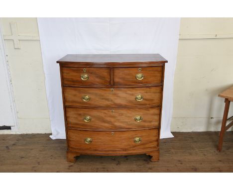 A Victorian mahogany bow front chest of two short and three long drawers with embossed fleur-de-lys decorated brass back plat