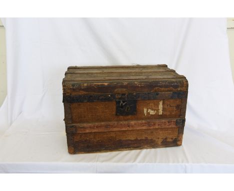 A canvas and wrought iron bound travelling trunk with twin carrying handles.  Initialled to each end M.H.C  21ins wide.  Est 