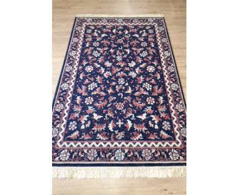 A FRINGED FLORAL PATTERNED CARPET 243 X 172