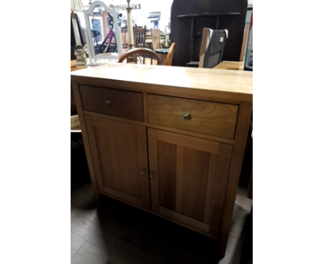 A LIGHT OAK TWO DRAWER CUPBOARD