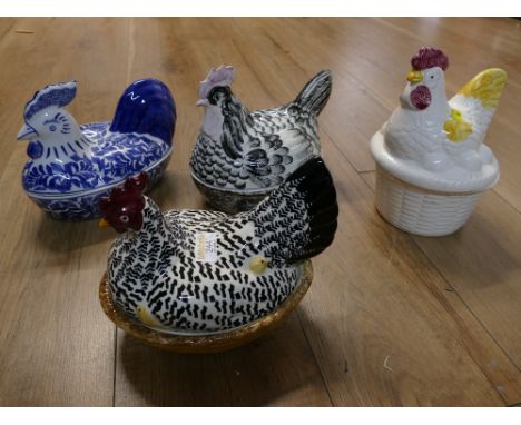 Four patterned ceramic hens on nests