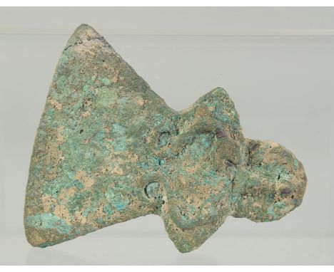 AN EARLY BRONZE AXE HEAD, with collar and triangular blade embellished with a heel in the shape of a jani form head, the coll