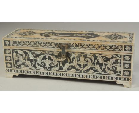 A TURKISH MOTHER OF PEARL INLAID RECTANGULAR BOX, the hinged lid with calligraphic panel, 28.5cm long.