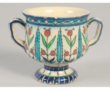 A 19TH CENTURY IZNIK STYLE TWIN HANDLE CUP, 9.5cm high.