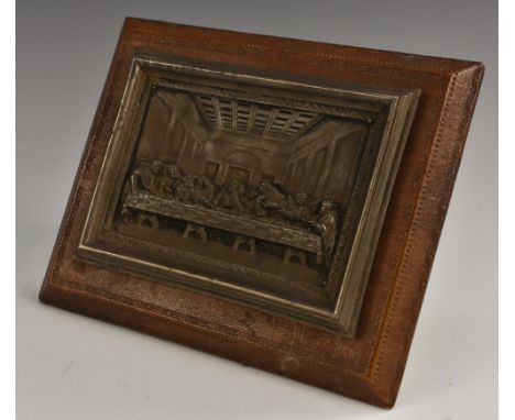 A Continental silver coloured metal rectangular plaque, embossed after Leonardo Da Vinci with The Last Supper, tooled and gil